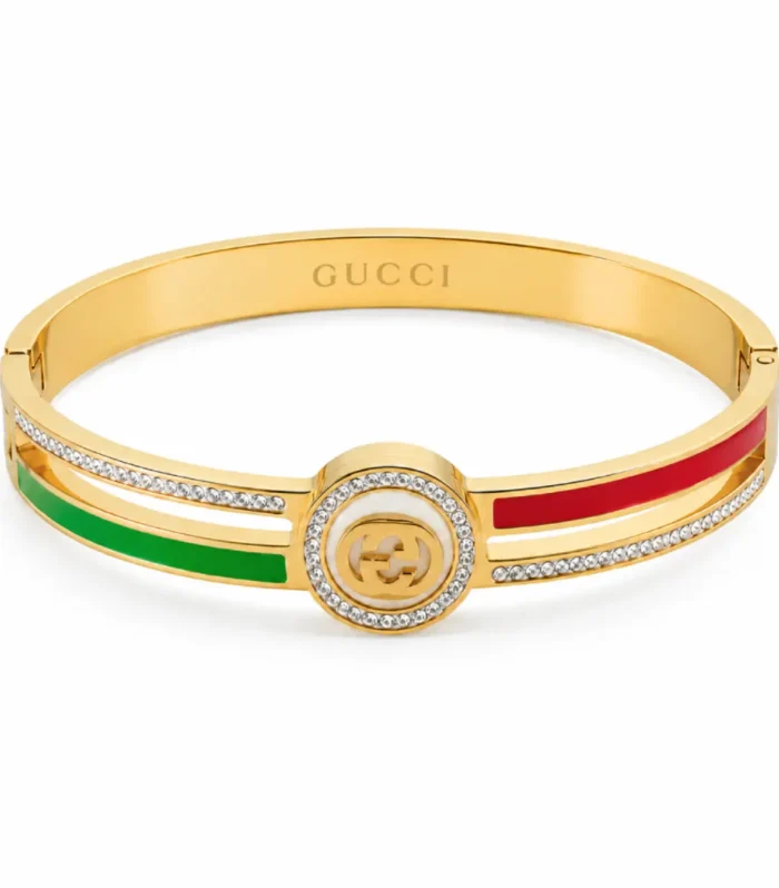 Luxury gold-tone bracelet with crystal detailing and green-red enamel stripe design inspired by Italian fashion aesthetics.